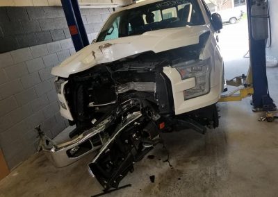 white van after the accident and before auto repair and auto body repair